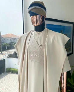 A coconut ivory, jakan design agbada, 3/4 sleeve buba laced with Swarovski stone button details and sokoto