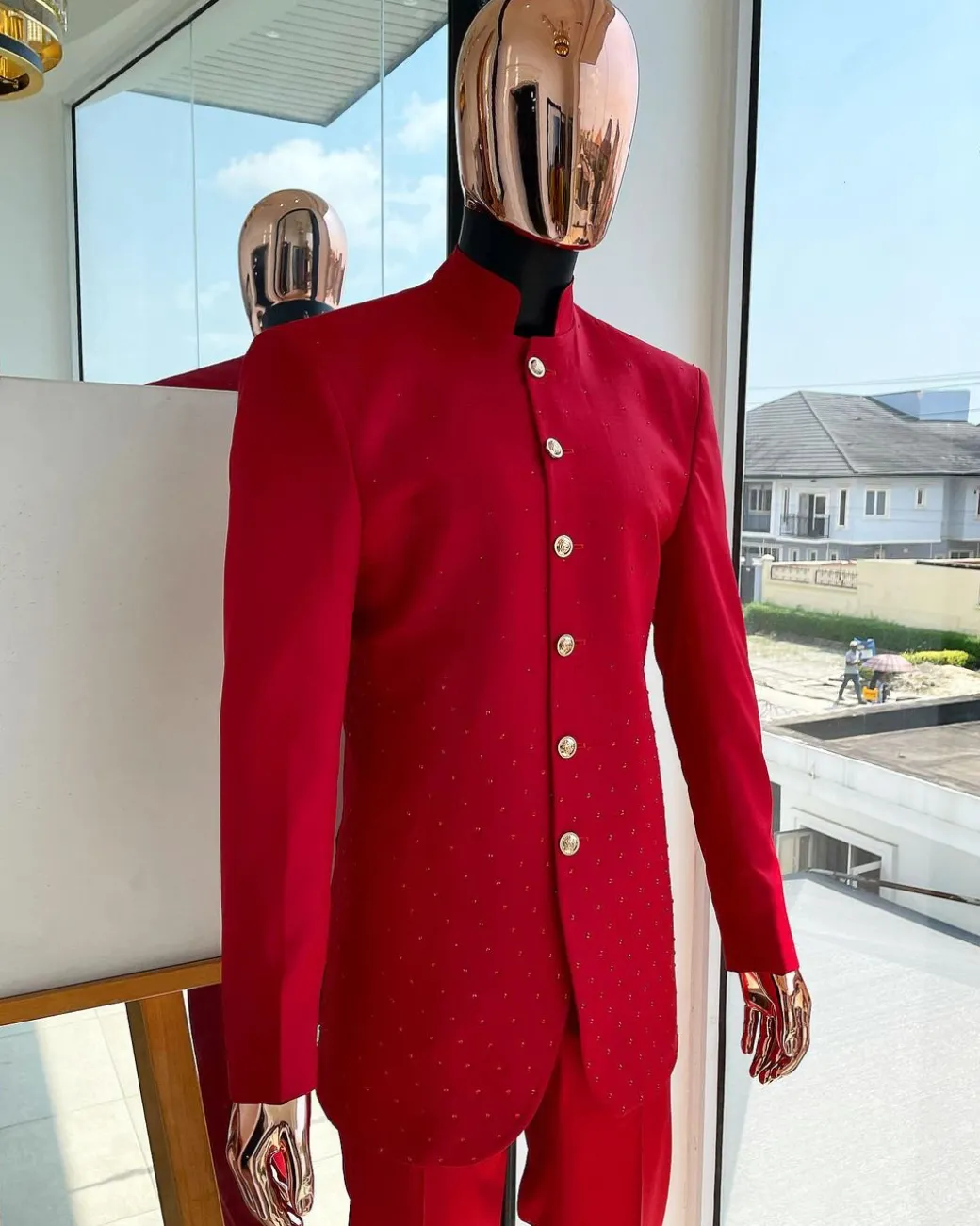 A Crimson red safari suit with matching Swarovski stones detailing