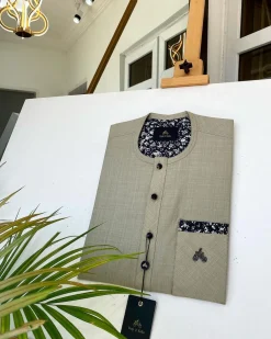 A Dark cream African kaftan with a clear view of Swarovski and buttons with paisley detailing