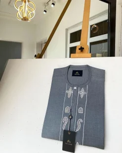 A Dark grey Irish petal embroidery detail and a mid-section flap button Swarovski African kaftan