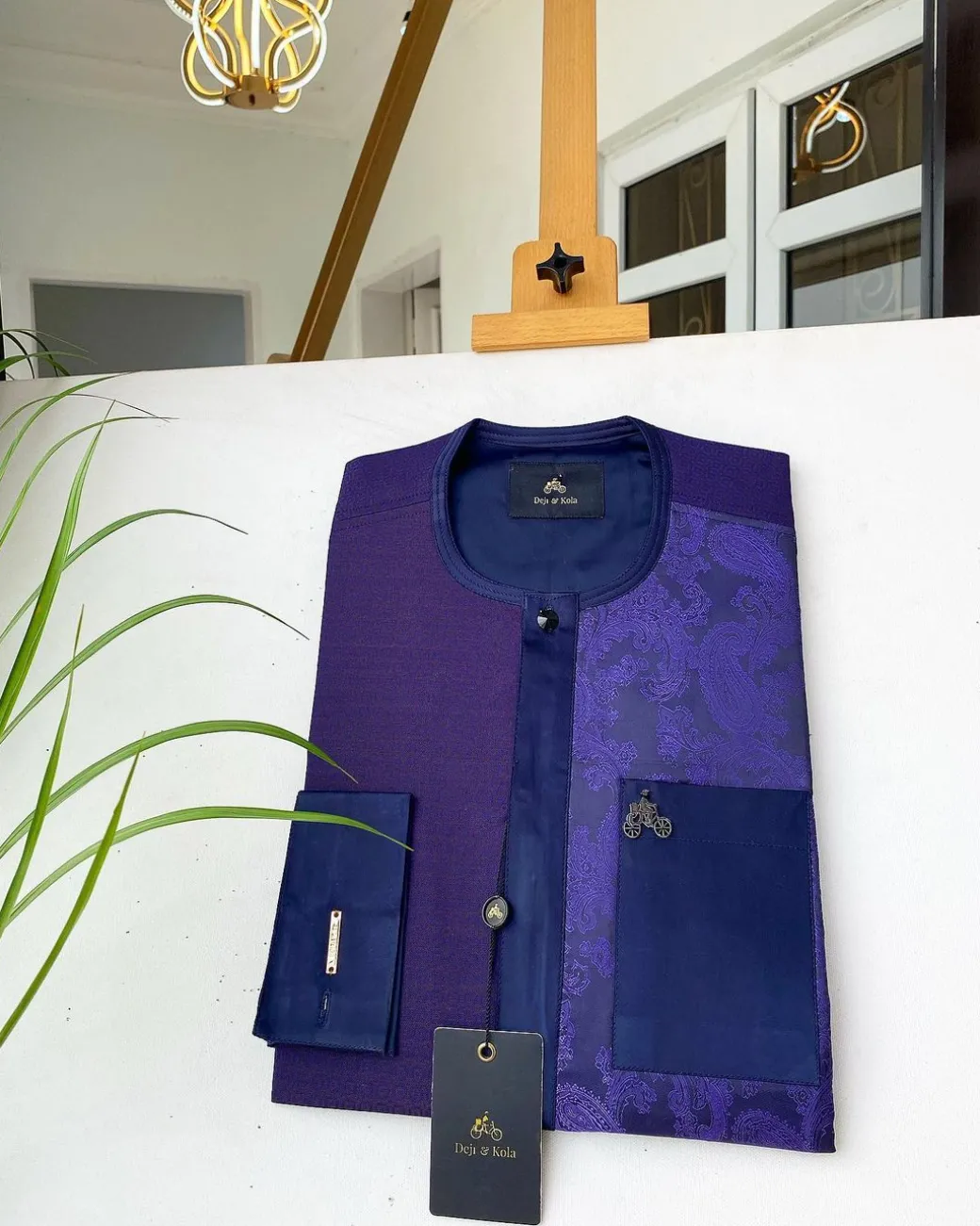 A dark purple matching paisley left section, and a silk blue flap and pocket with a Swarovski African Kaftan