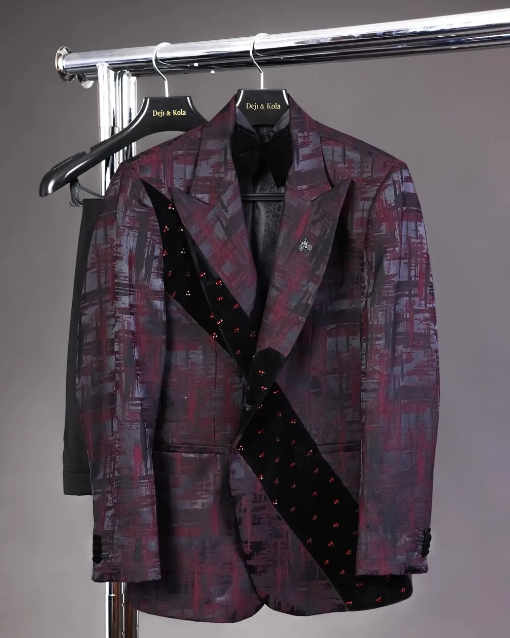 A diagonal cut layered black velvet Swarovski detailing burgundy and black patterned suit
