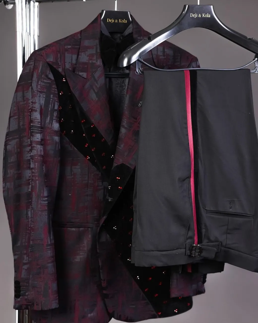 A diagonal cut layered black velvet Swarovski detailing burgundy and black patterned suit