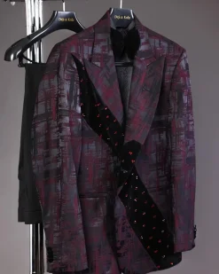 A diagonal cut layered black velvet Swarovski detailing burgundy and black patterned suit