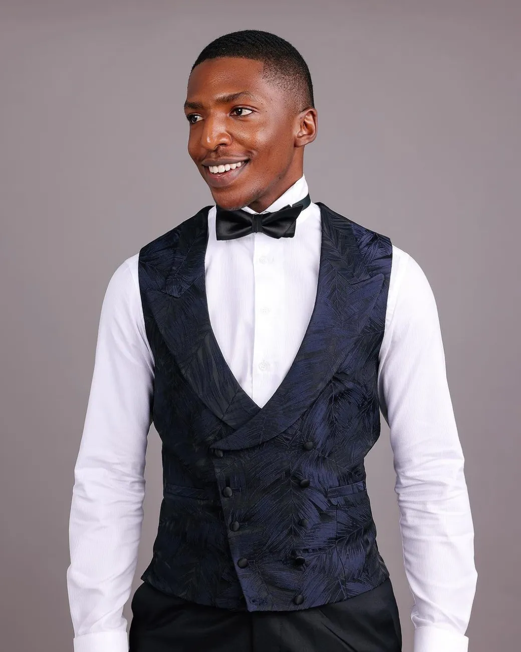 A Double-Breasted, Curved Peak Lapel Waistcoat.