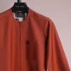 A fire orange and black pencil stripe, zipline, 3/4 sleeve African senator kaftan native.