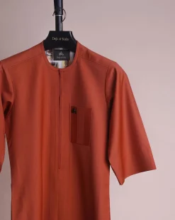 A fire orange and black pencil stripe, zipline, 3/4 sleeve African senator kaftan native.