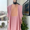 A Flamingo pink, monochrome spiral embroidery detailing Agbada