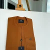 A ginger orange, mid section embrodery front flap with a symmetric lane patch pocket African traditional kaftan native.