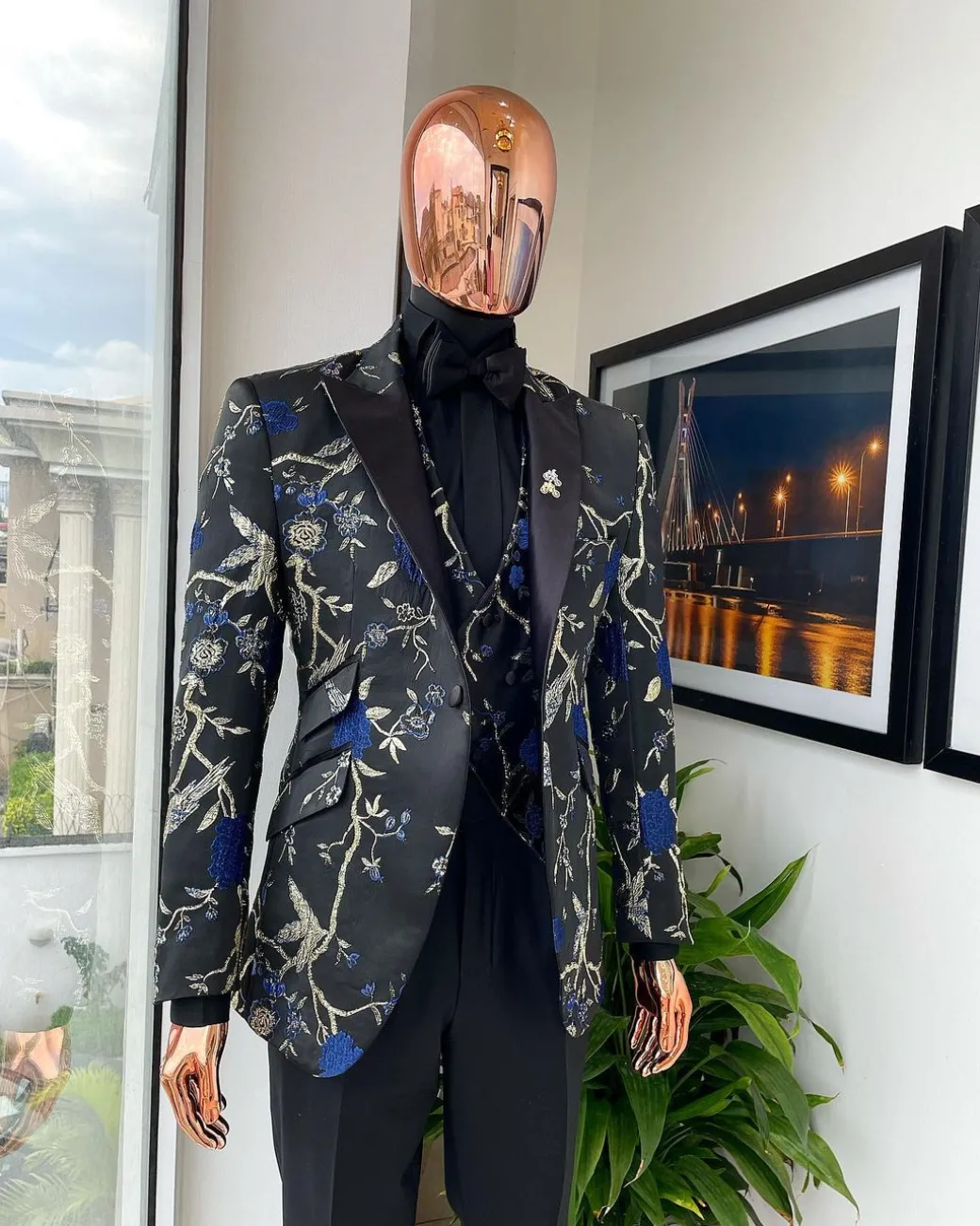 A Gold, black, and blue peak lapel, raven, and forest metallic pattern jacquard dinner suit