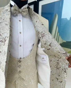 A gold print pattern tuxedo suit, contemplation cream with maroon, champagne gold floral metallic jacquard shawl lapel