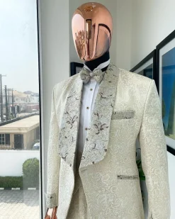 A gold print pattern tuxedo suit, contemplation cream with maroon, champagne gold floral metallic jacquard shawl lapel