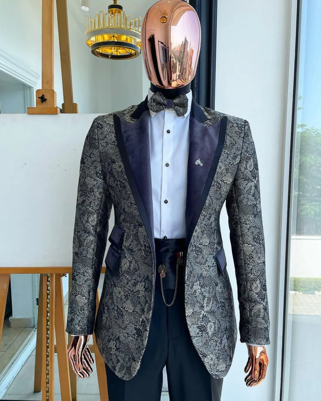 A grey floral jacquard peak lapel with black silk taping tuxedo suit