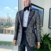 A grey floral jacquard, peak lapel with black silk taping tuxedo suit