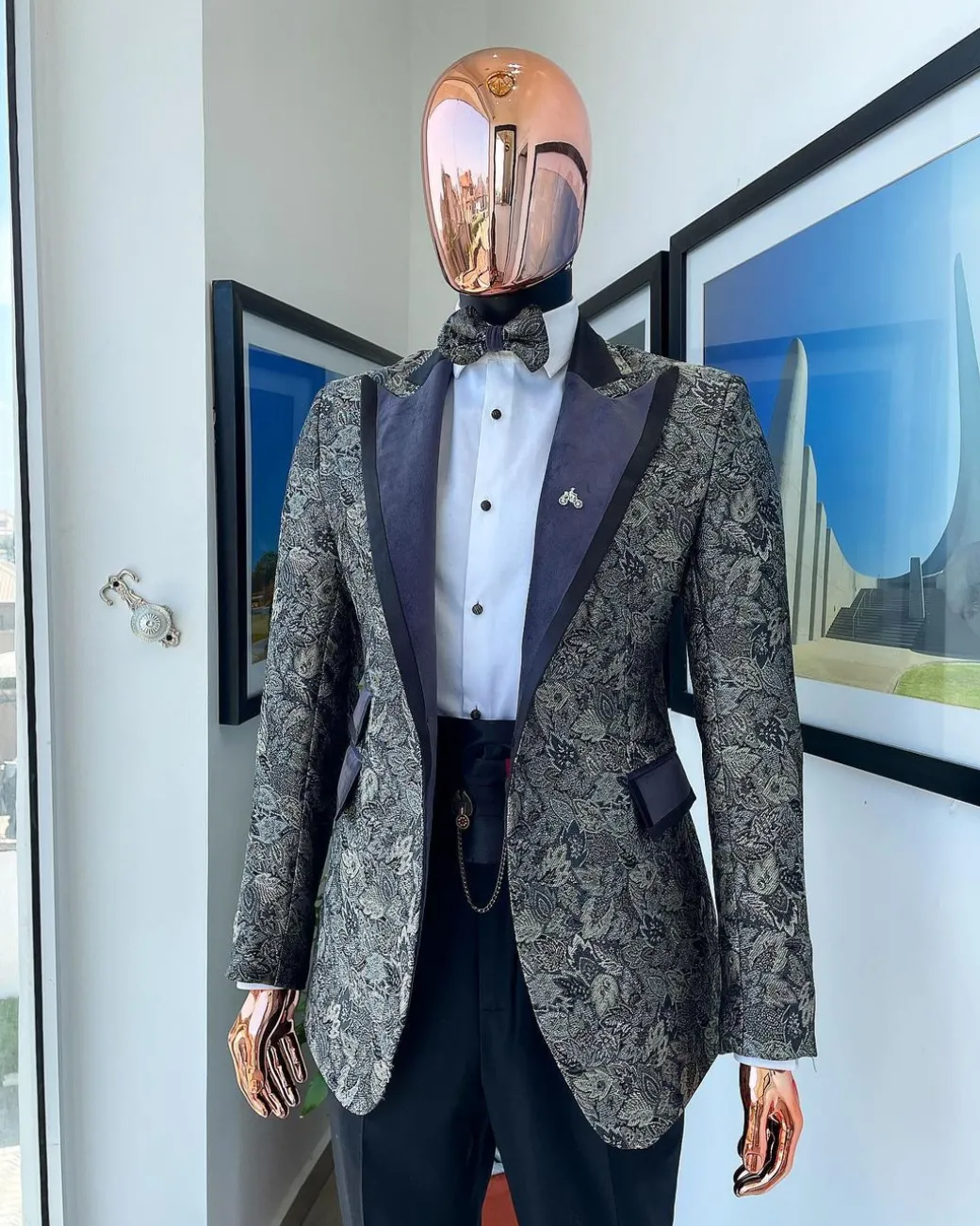 A grey floral jacquard peak lapel with black silk taping tuxedo suit