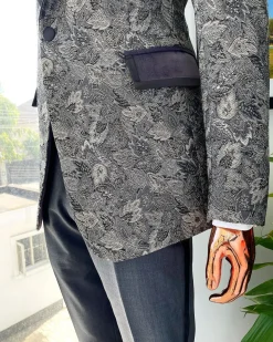 A grey floral jacquard, peak lapel with black silk taping tuxedo suit