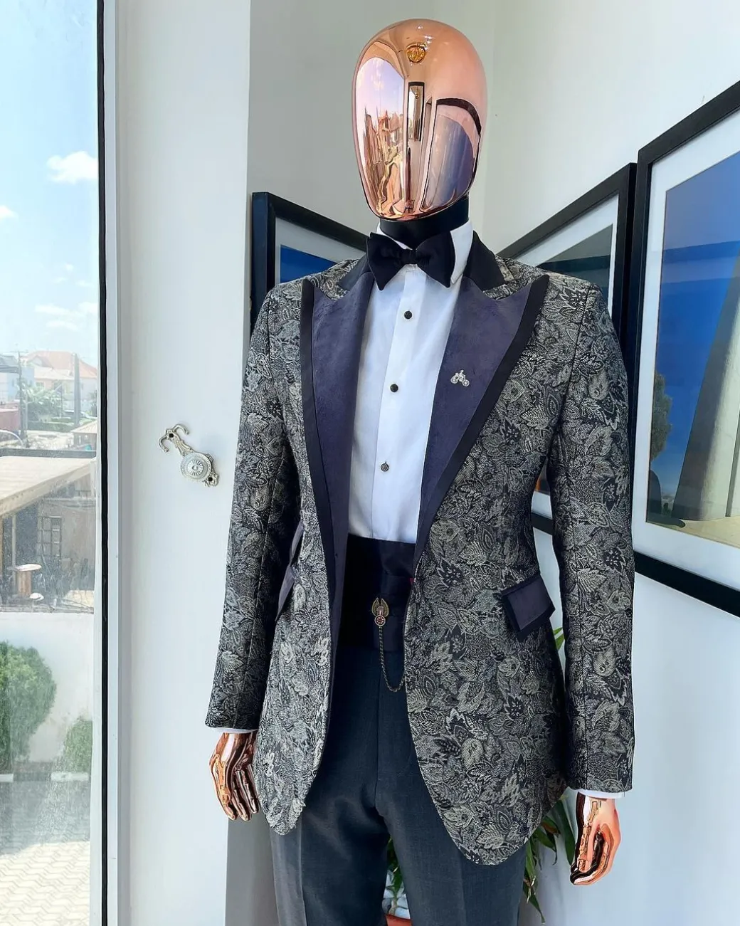 A grey floral jacquard, peak lapel with black silk taping tuxedo suit