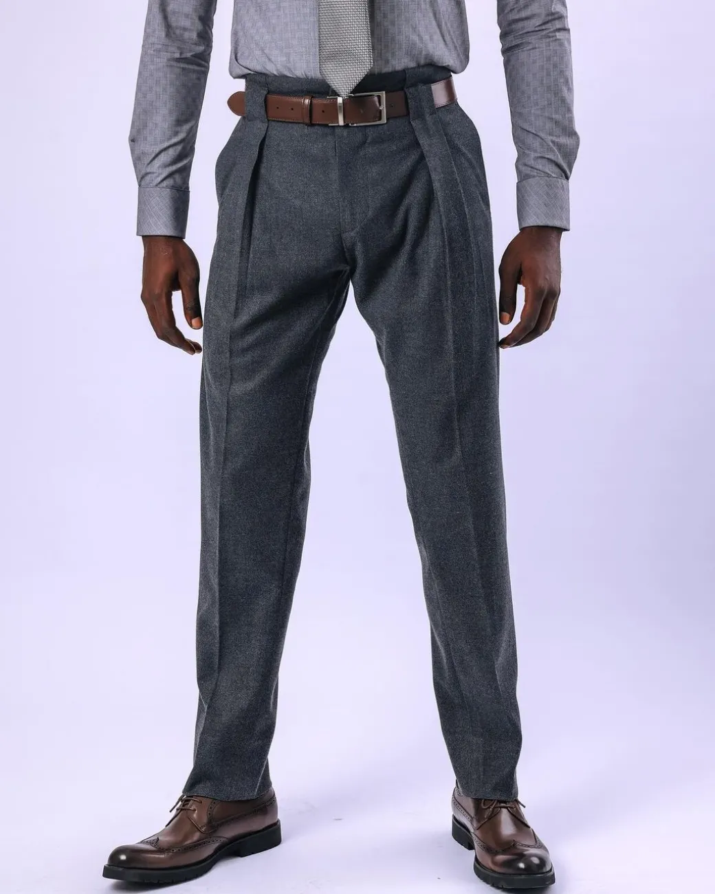 A Grey Gurkha pant with a covered belt tab and double pleats.