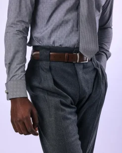 A Grey Gurkha pant with a covered belt tab and double pleats.