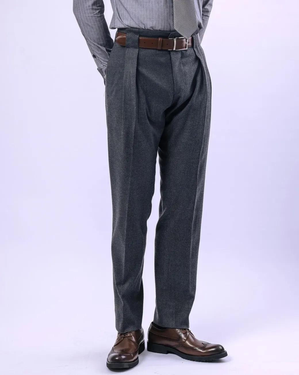 A Grey Gurkha pant with a covered belt tab and double pleats.