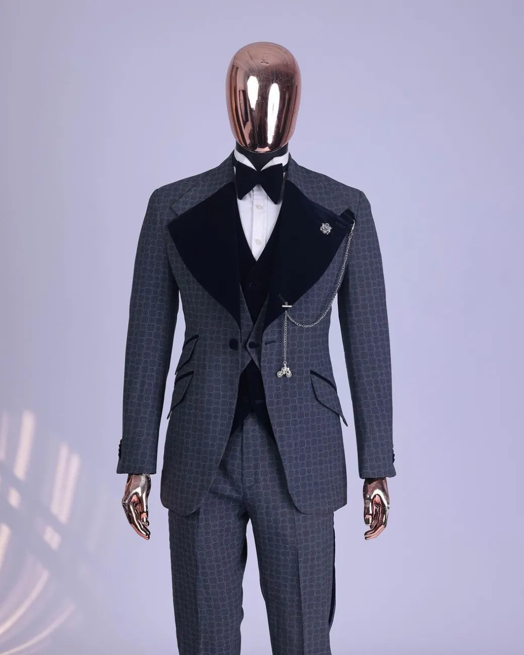 A grey octagonal patterned, navy blue mix, wide notch lapel, single button suit