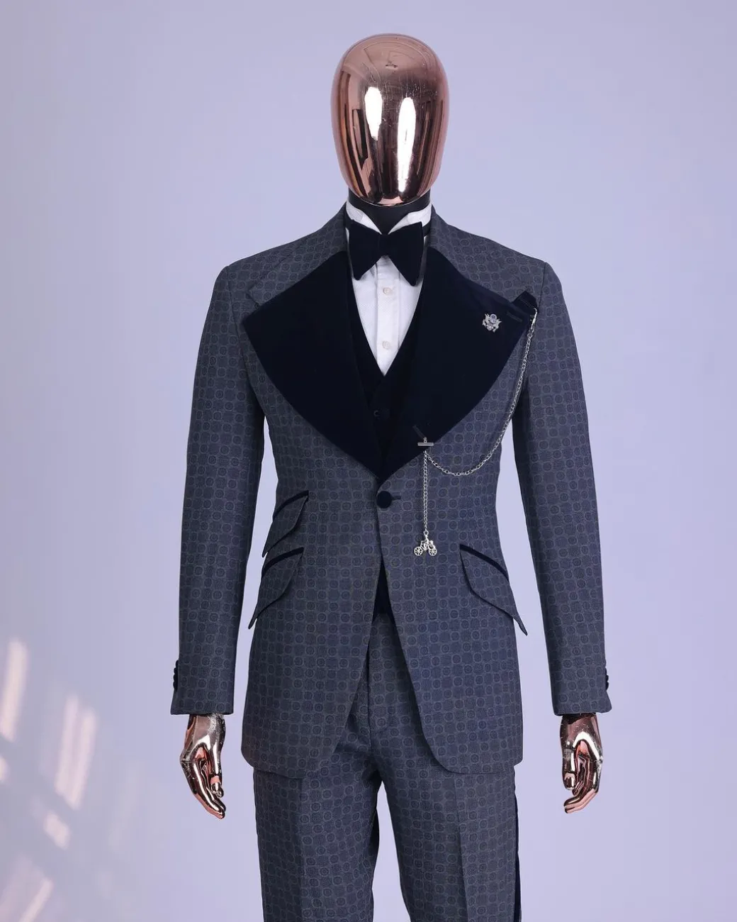 A grey octagonal patterned, navy blue mix, wide notch lapel, single button suit
