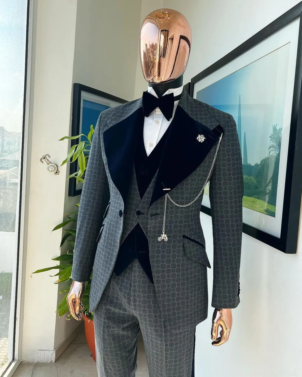 A grey octagonal patterned, navy blue mix, wide notch lapel, single button suit
