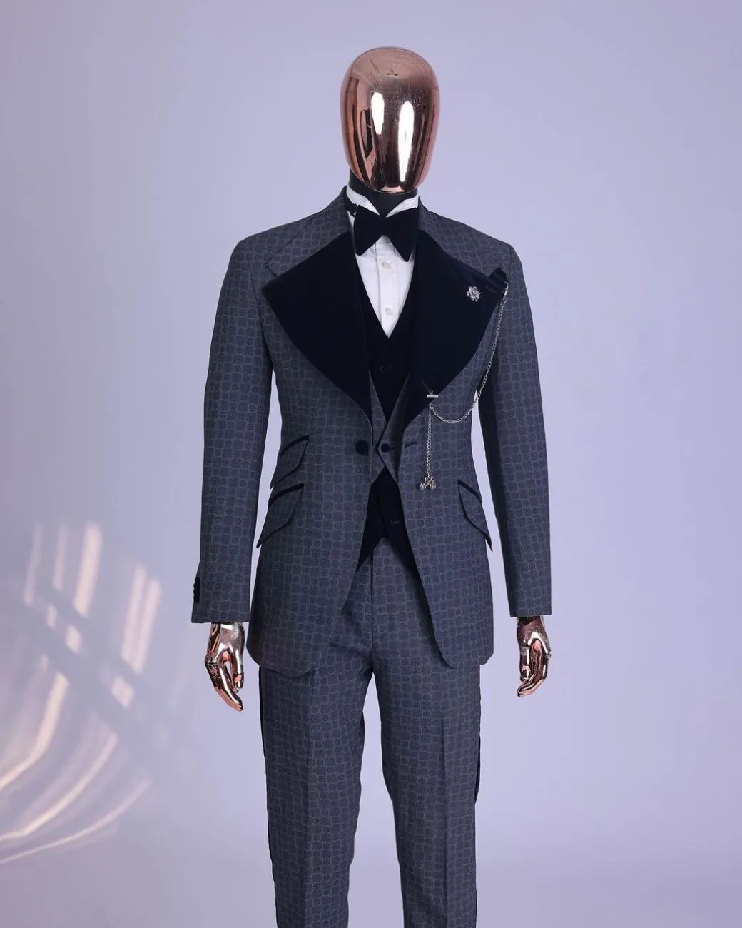 A grey octagonal patterned, navy blue mix, wide notch lapel, single button suit