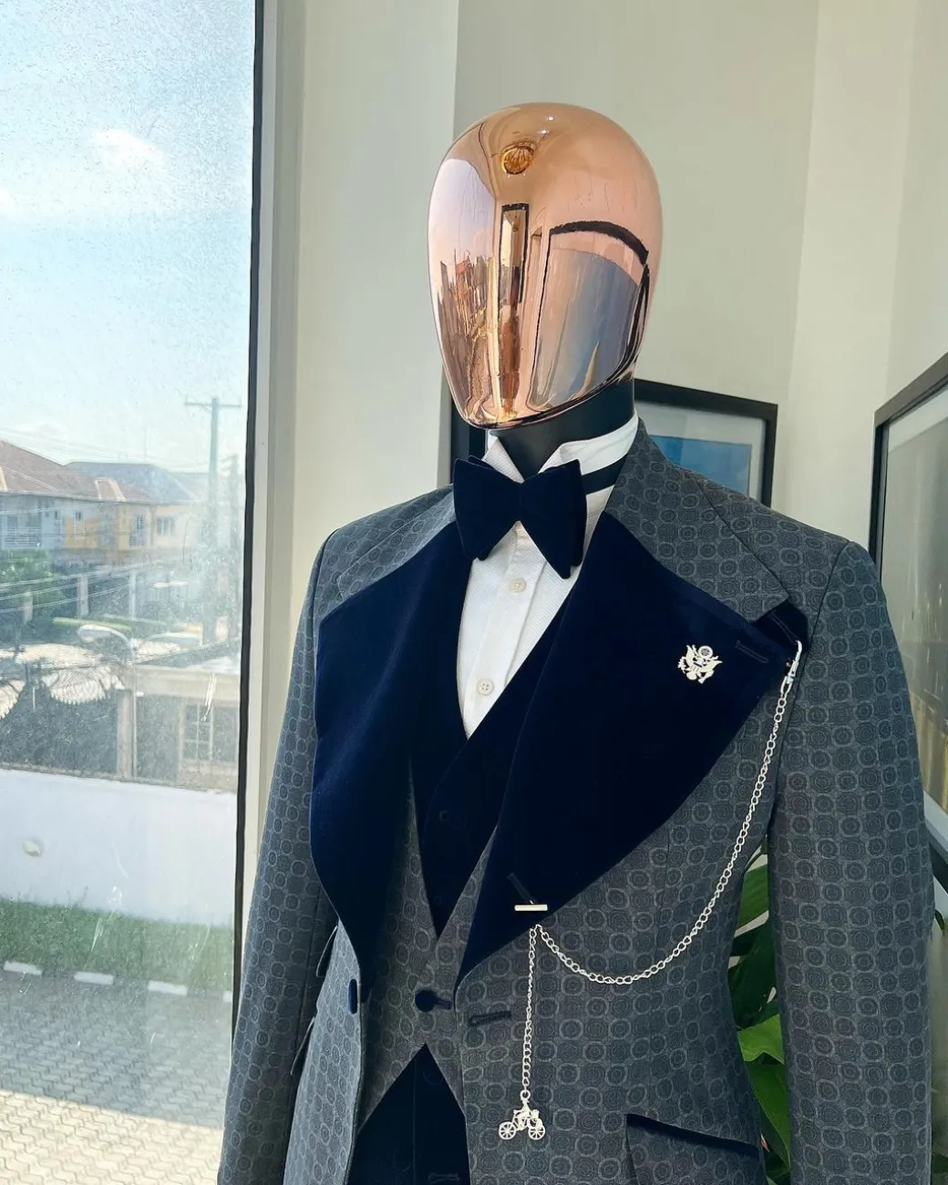 A grey octagonal patterned, navy blue mix, wide notch lapel, single button suit