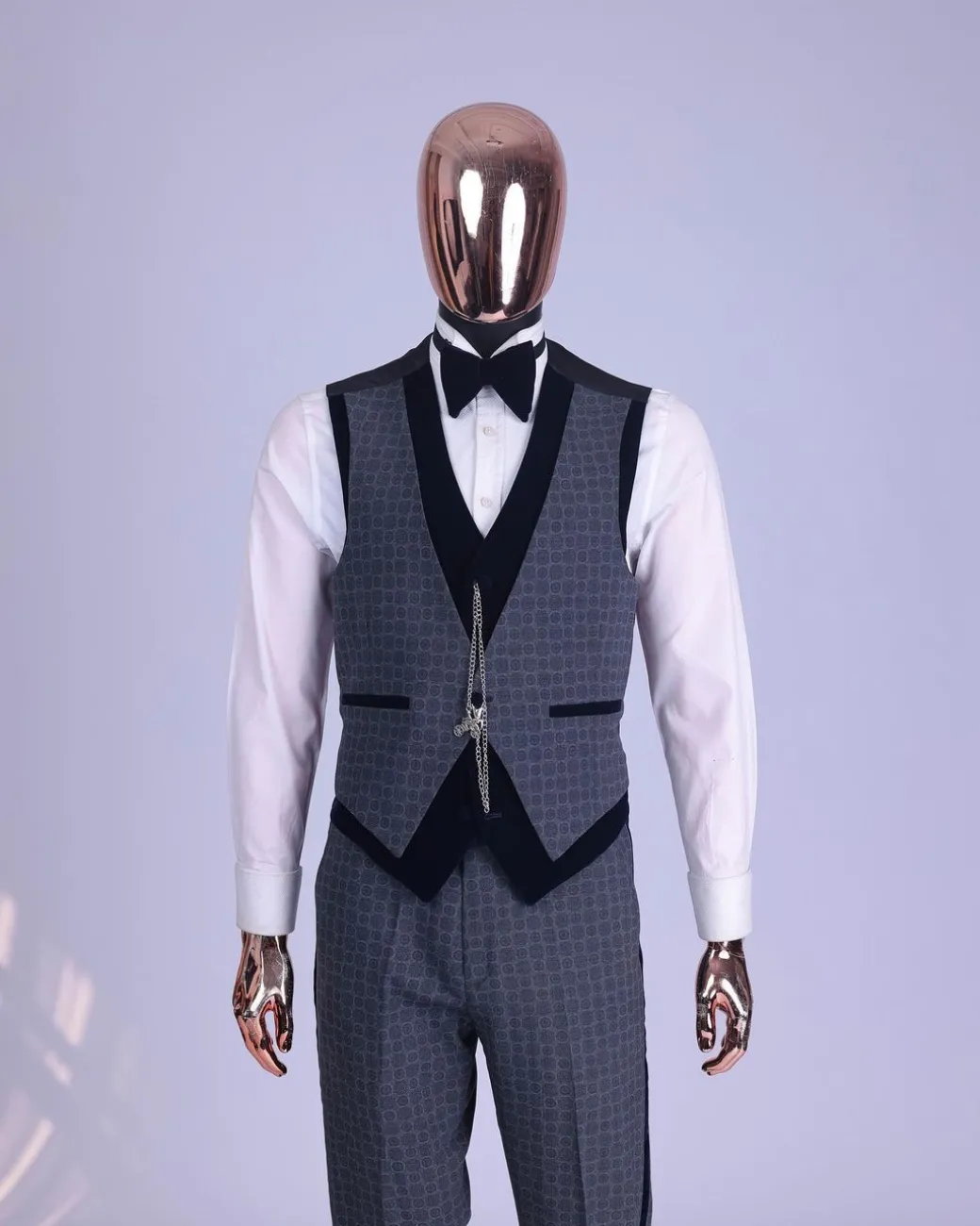 A grey octagonal patterned, navy blue mix, wide notch lapel, single button suit