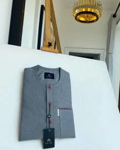 A grey, patch pocket and front flap with a clear view lipstick red Swarovski African kaftan