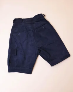A “Gurkha”pant shorts with pleats, double side strap buckle, combat patch pocket.