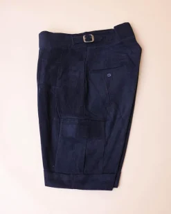 A “Gurkha”pant shorts with pleats, double side strap buckle, combat patch pocket.