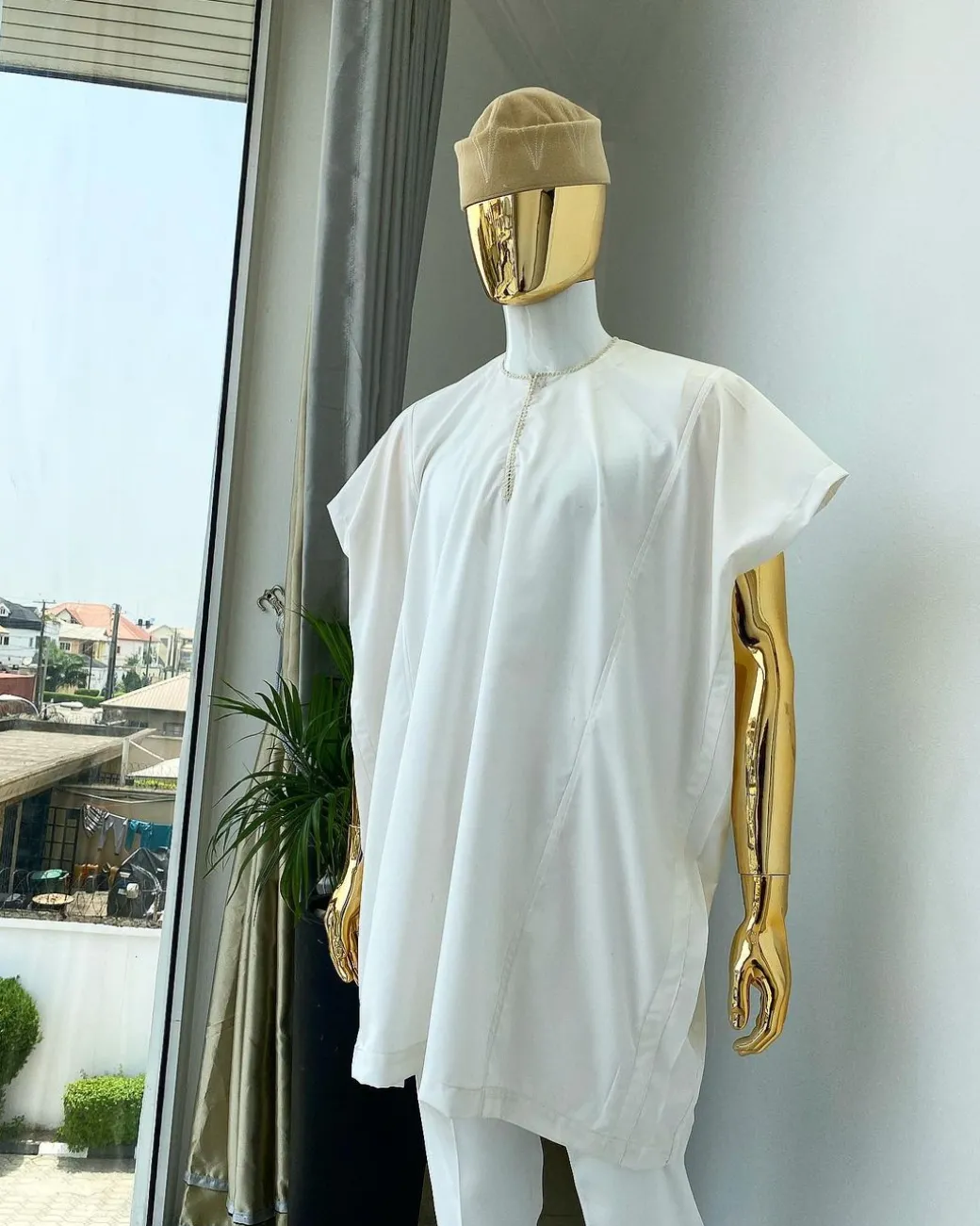 A Hand picked (jakan design) ivory white dashiki buba, sokoto & a cream patterned wool hat.
