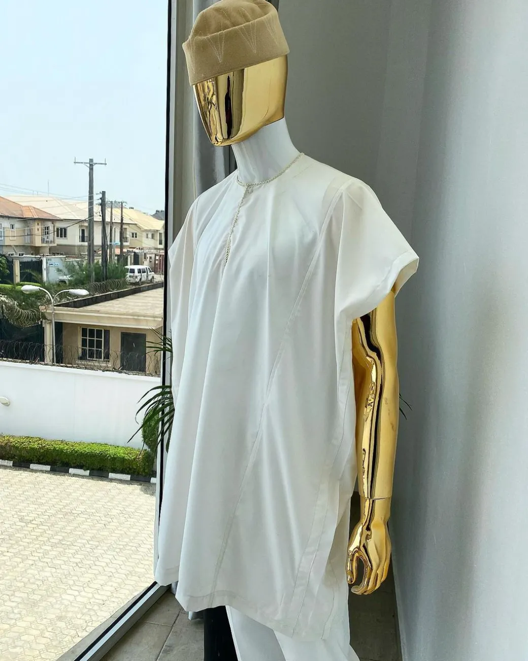 A Hand picked (jakan design) ivory white dashiki buba, sokoto & a cream patterned wool hat.