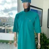 A Jade Green, front flap, valley perspective pocket design and Swarovski button details african traditional kaftan native.