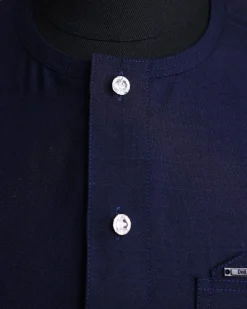 A Jorgecarli wool, midnight blue, invisible windowpane check, front flap with silver Swarovski button, shorts sleeve African senator kaftan native.