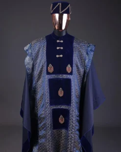A “krosscut” layered, minted Gold, Skye, navy and admiral blue mix metallic jacquard front cut agbada.