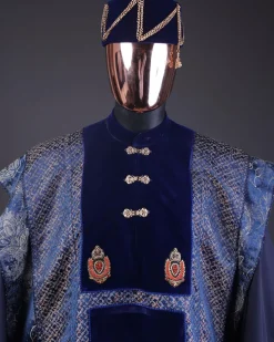 A “krosscut” layered, minted Gold, Skye, navy and admiral blue mix metallic jacquard front cut agbada.
