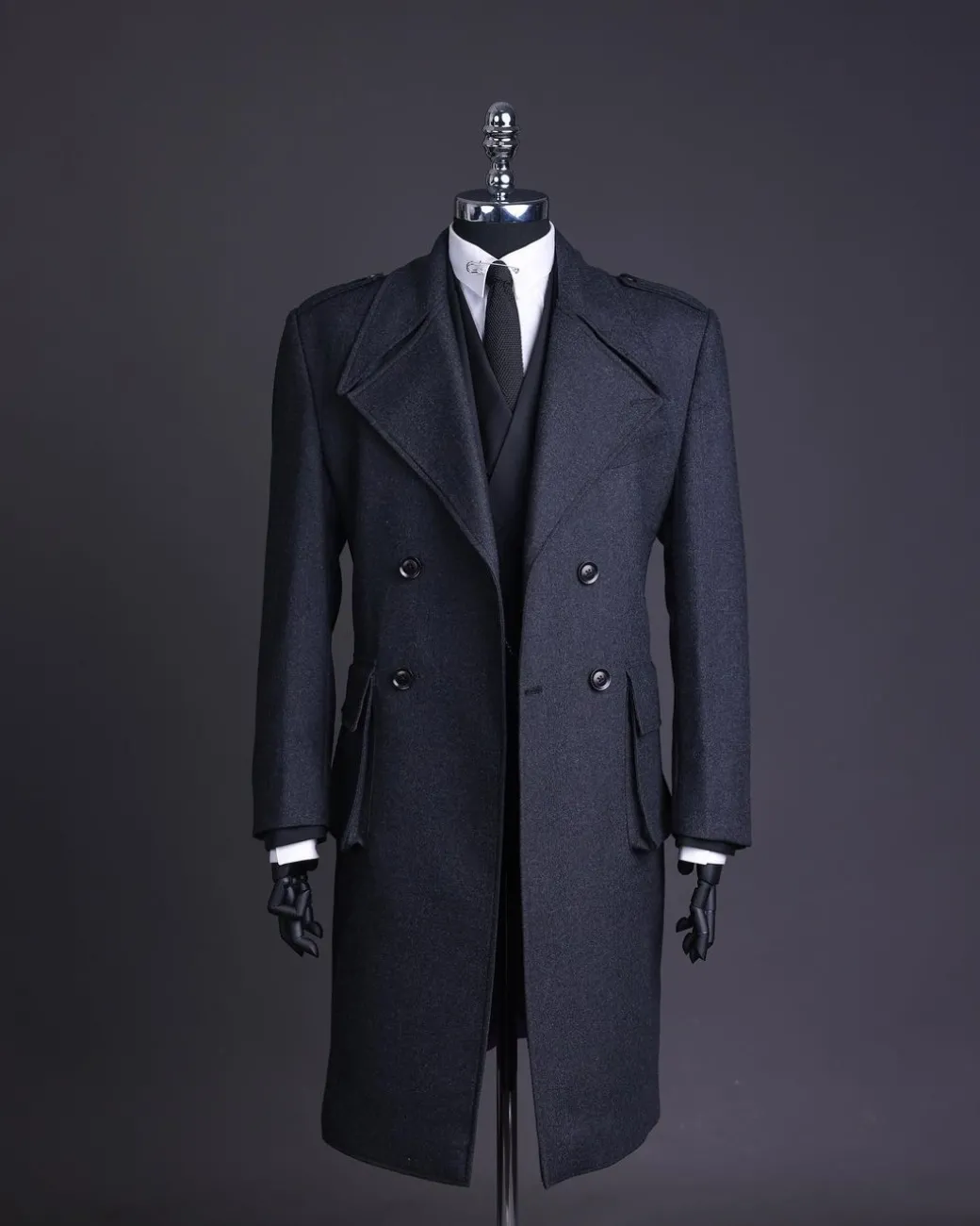 A Lead grey, double breasted, notch lapel trench coat with combat pocket.