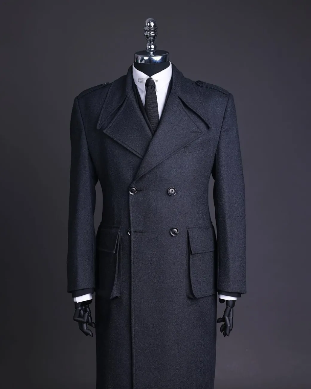 A Lead grey, double breasted, notch lapel trench coat with combat pocket.
