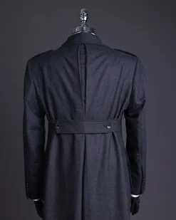 A Lead grey, double breasted, notch lapel trench coat with combat pocket.