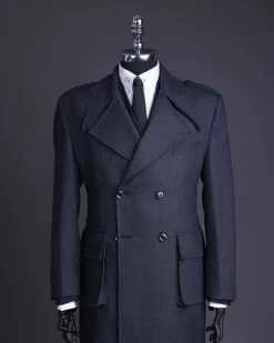 A Lead grey, double breasted, notch lapel trench coat with combat pocket.