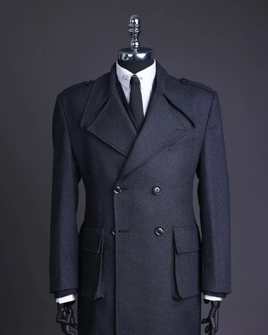 A Lead grey, double breasted, notch lapel trench coat with combat pocket.