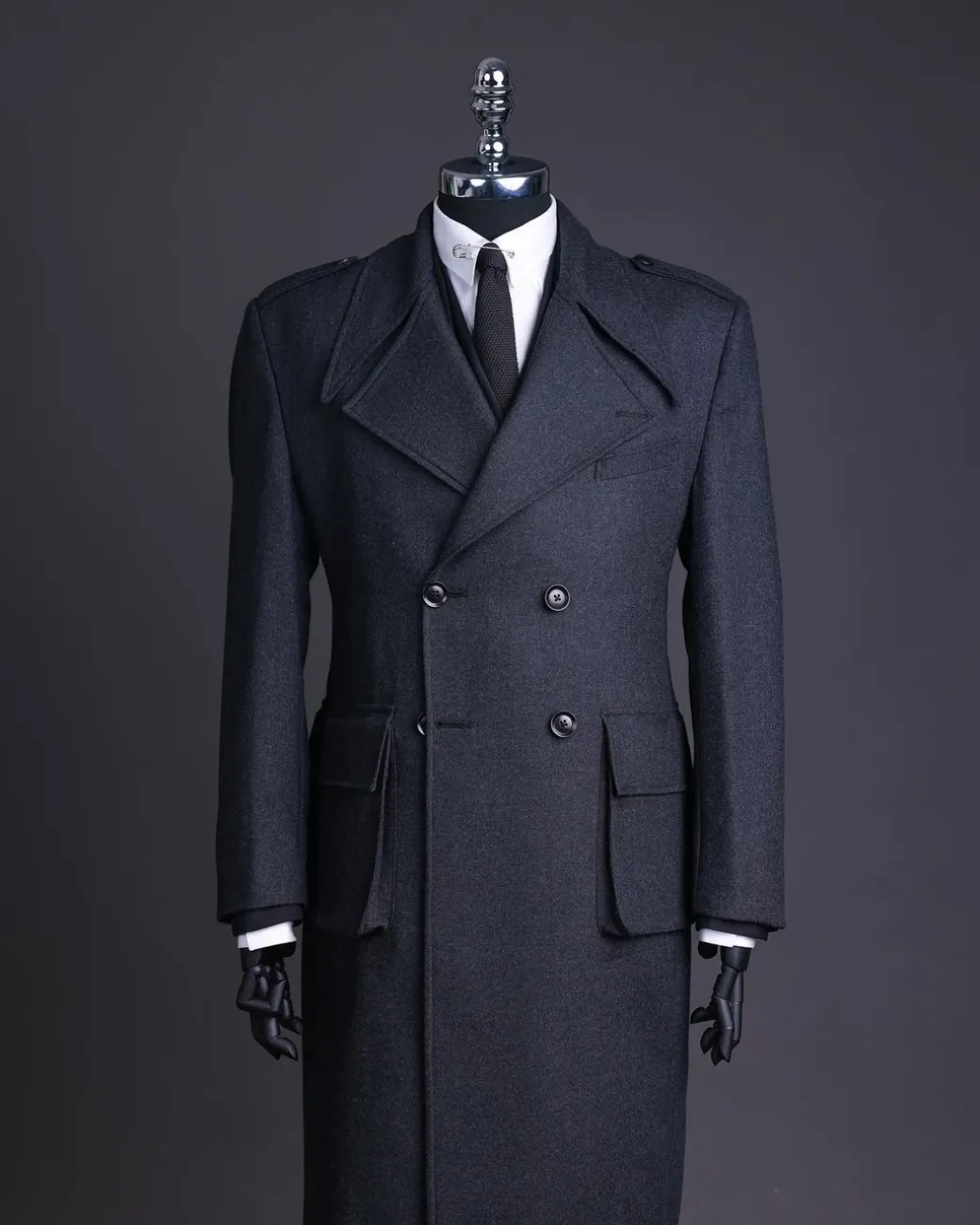 A Lead grey, double breasted, notch lapel trench coat with combat pocket.
