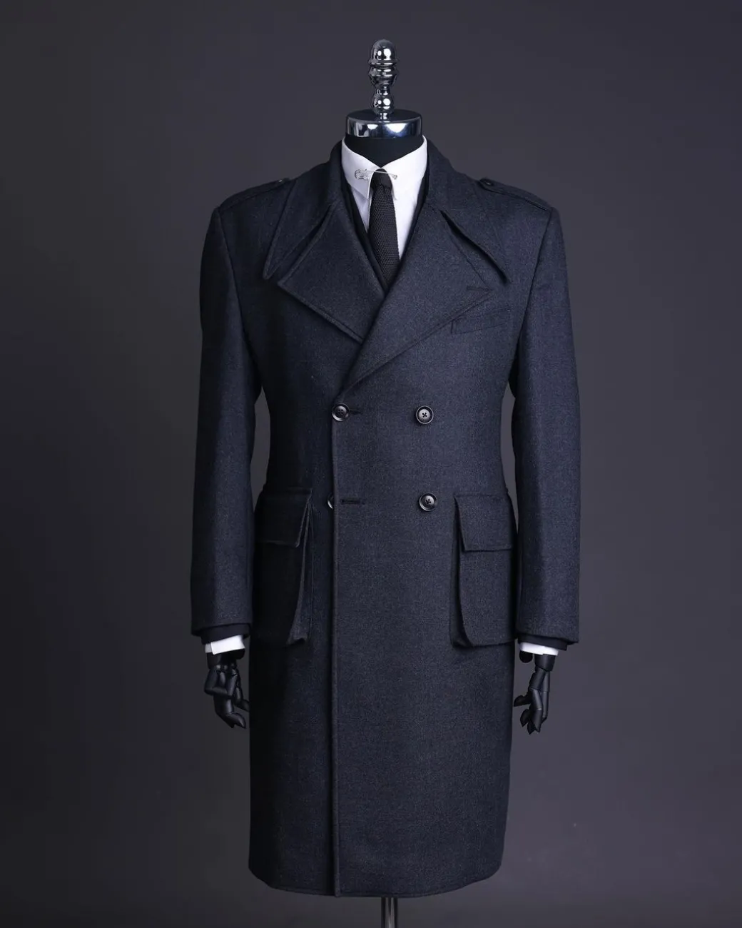 A Lead grey, double breasted, notch lapel trench coat with combat pocket.