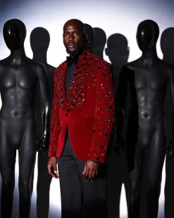 A Mahogany red shawl lapel tuxedo with black and octagonal laser-cut matching Swarovski stones suit