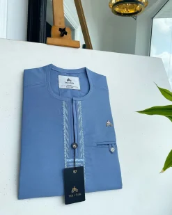 A Maya blue rail line flap with a combat pocket Swarovski button details African traditional senator Kaftan.