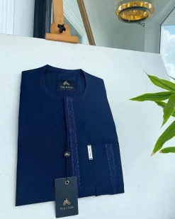 A midnight blue front flap with a line embroidery detail African traditional senator kaftan native