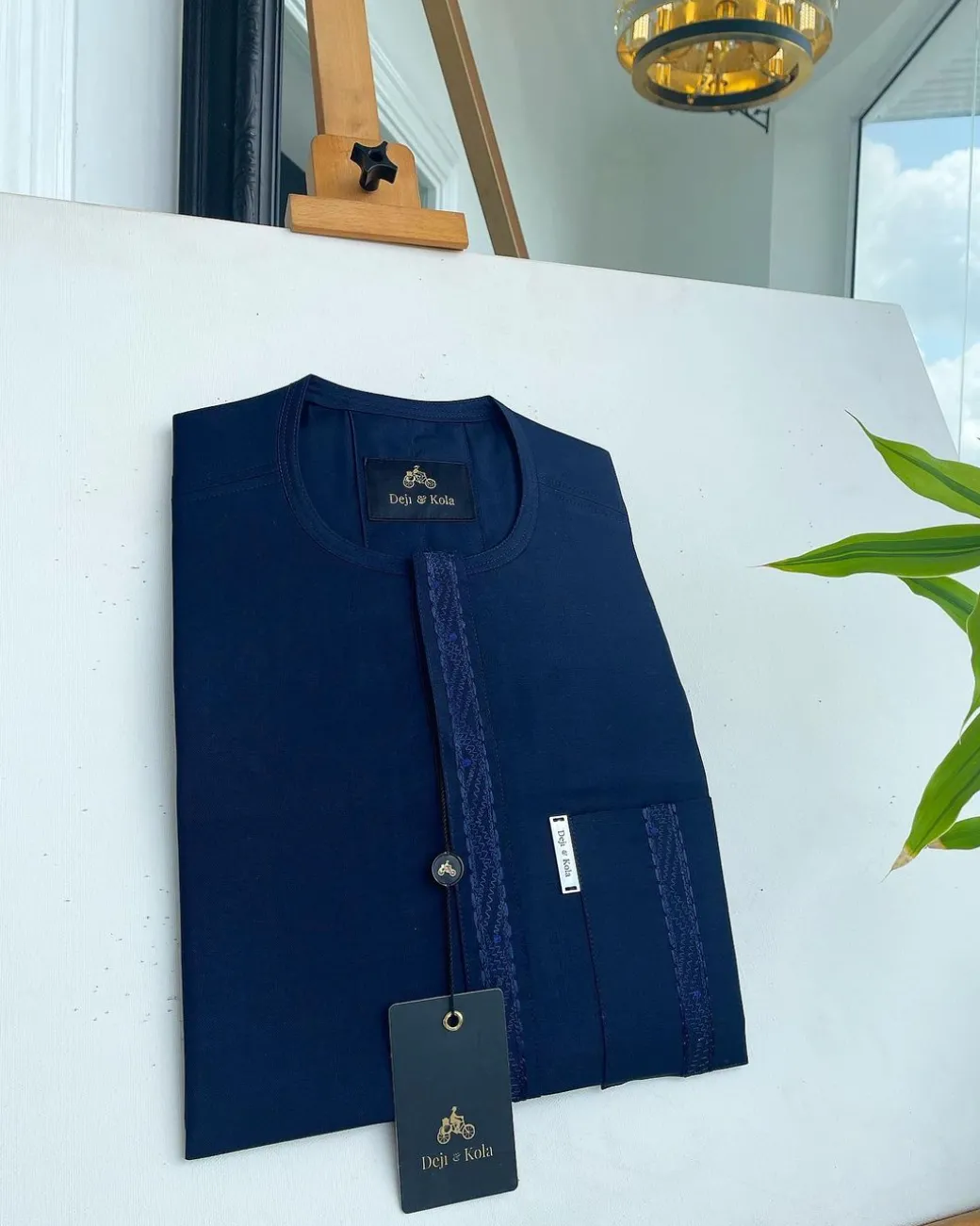 A midnight blue front flap with a line embroidery detail African traditional senator kaftan native